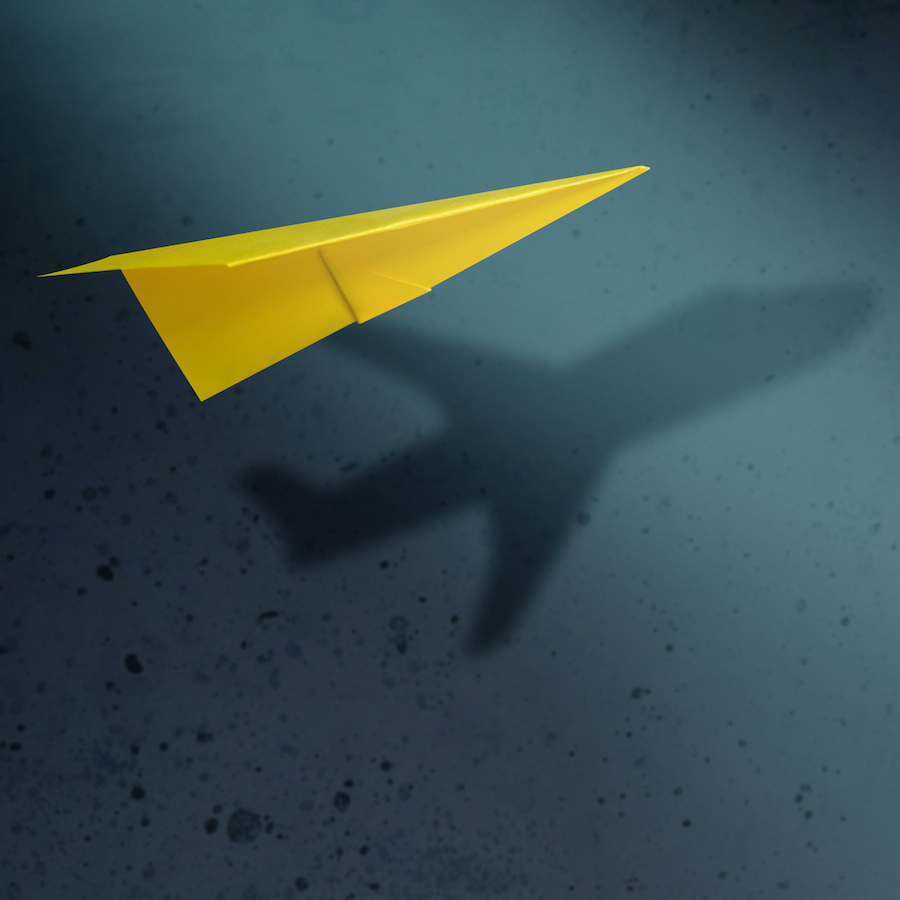 Think Big and Motivation in Business Concept. Paper AirPlanes Flying with Shadow of Aircraft over the Wall